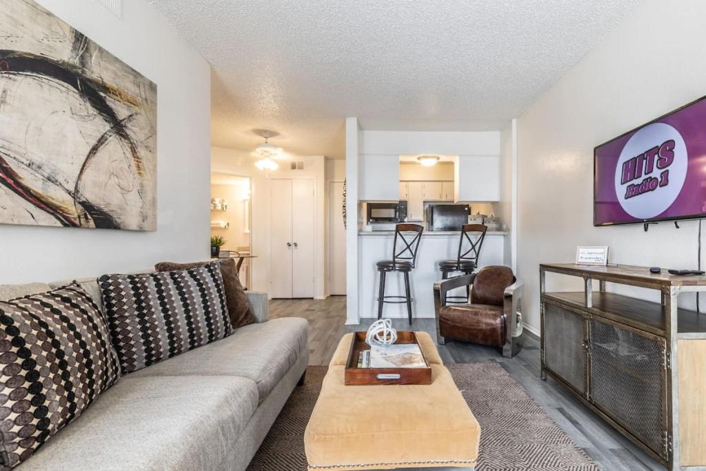 a living room with a couch and a table at Cozy North Dallas One Bedroom Stay in Dallas