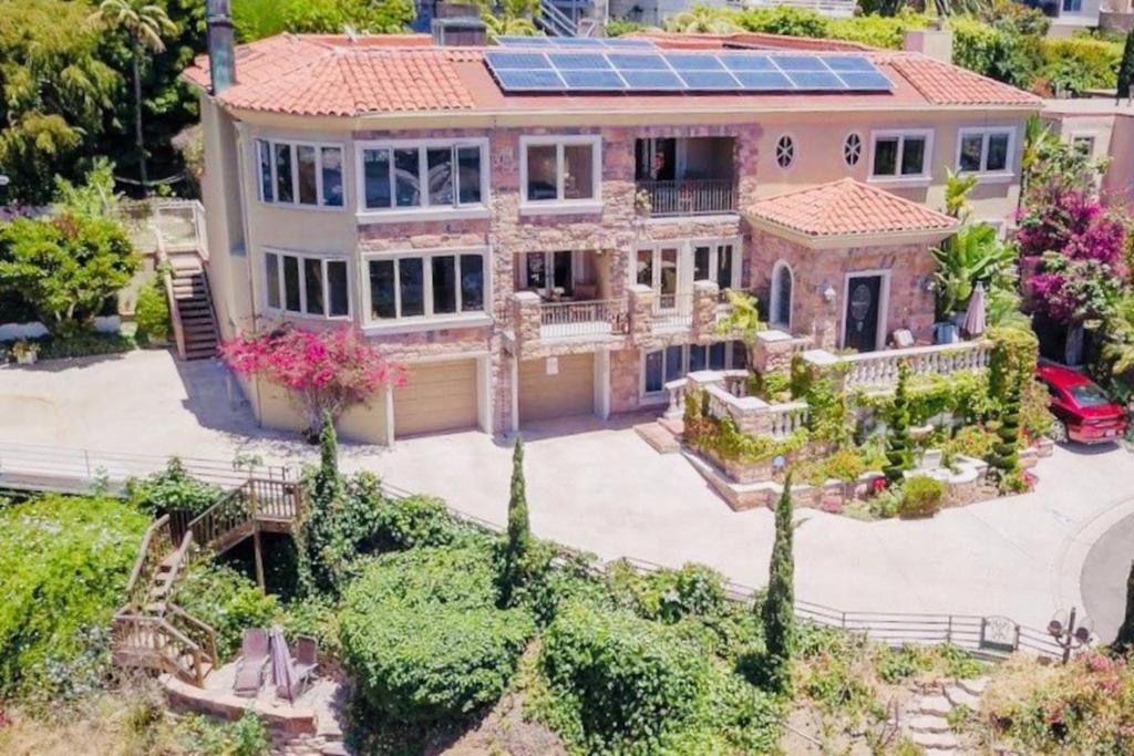 an aerial view of a house with a solar roof at UNEQUALLED LUXURY VILLA BEACH 7000ft 180 VIEW in Laguna Beach