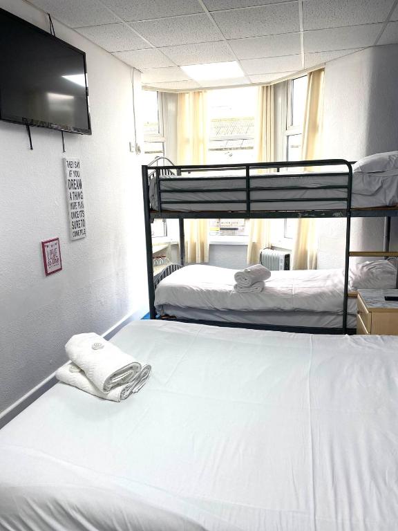 two bunk beds in a room with a tv at The Regency Hotel in Blackpool