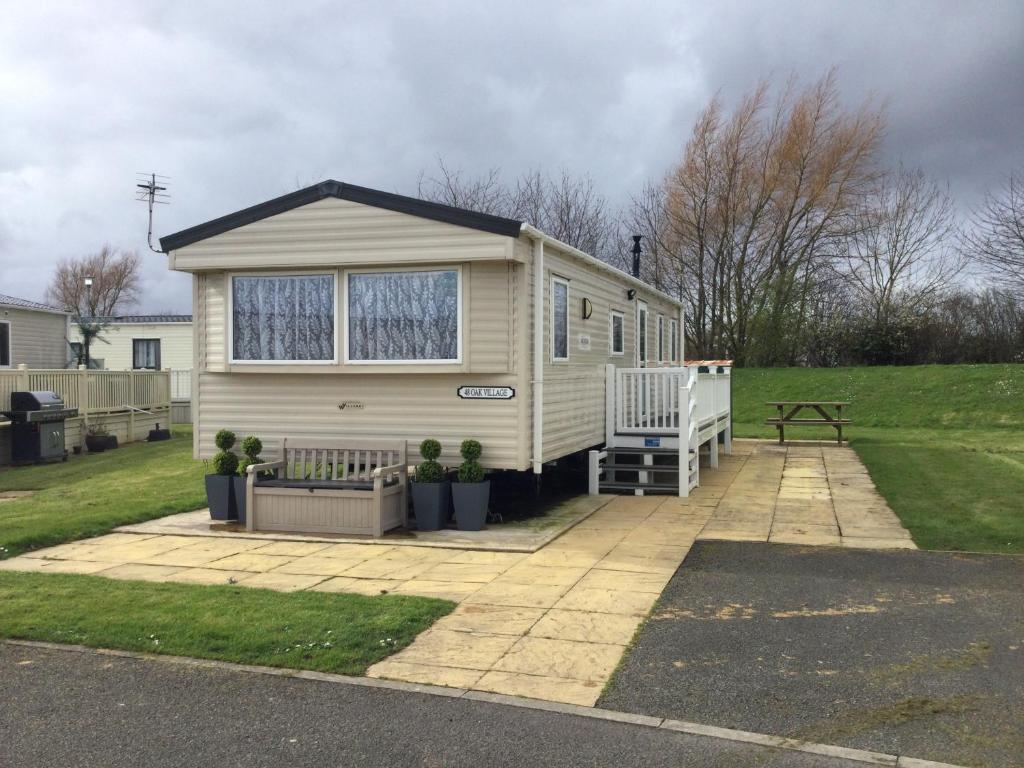 a tiny house is sitting on a driveway at 48 Oak Village Grange Leisure Park in Mablethorpe