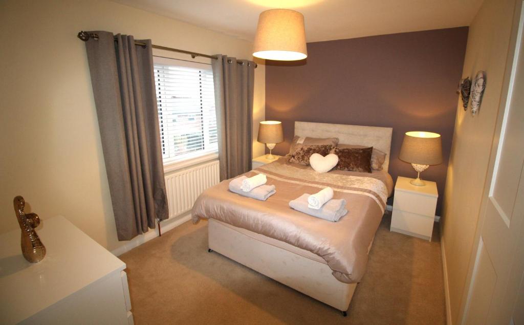 a bedroom with a bed with two pillows on it at Rowlands Gill - 3 Bedroom House - Fully Refurbished Throughout - New Kitchen & Bathroom - High Standard Throughout in Rowlands Gill