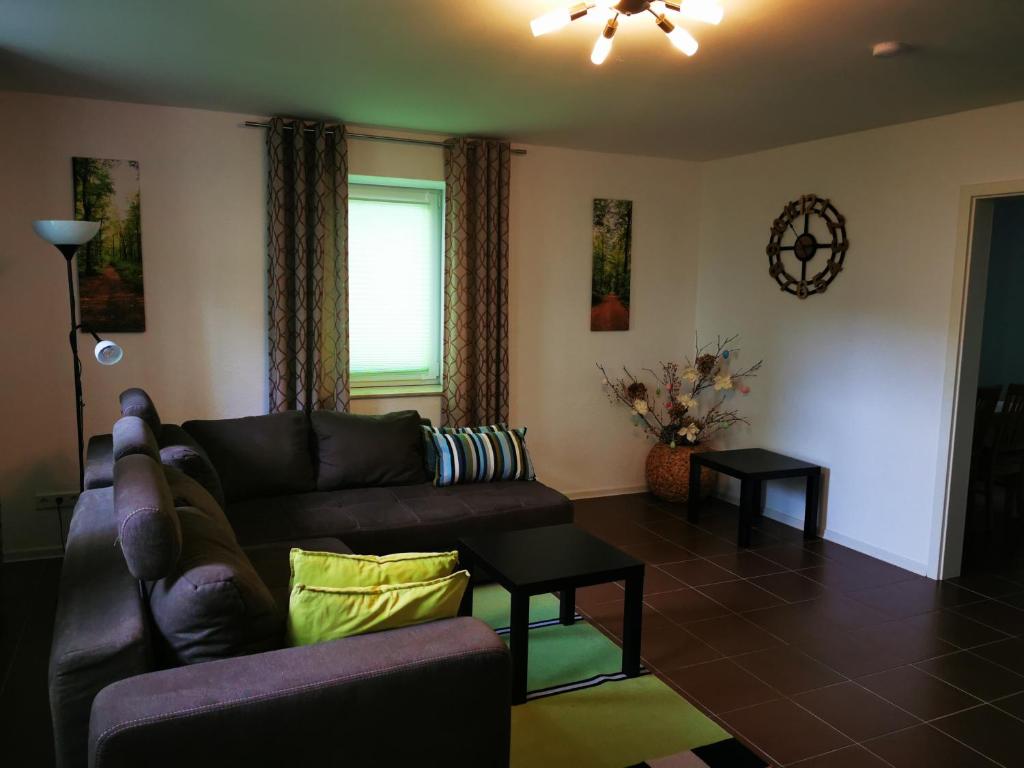 a living room with a couch and a table at Ferienwohnung am Waldpfad in Kaiserslautern