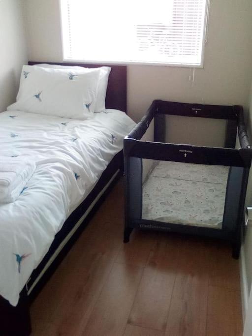 a bed in a room with a window and a bedskirtspectspectspectspects at 25. Valencia in Selsey