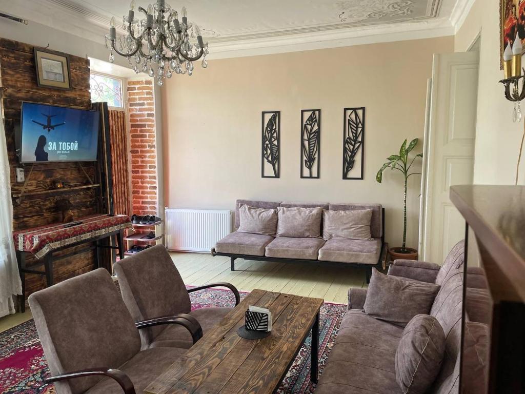 a living room with a couch and a tv at Old Gyumri in Gyumri