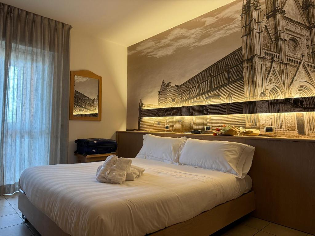 Postel nebo postele na pokoji v ubytování Hotel Cladan