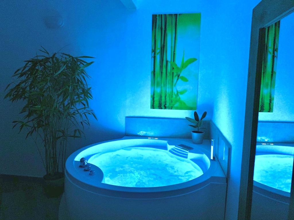 a bathroom with a jacuzzi tub with blue lighting at Dimora San Biagio Suites&Apartment in Lecce