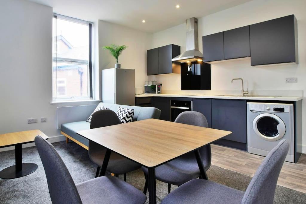a kitchen and dining room with a table and chairs at FREE PARKING - Charming 2-BR Flat near Salford Royal in Manchester