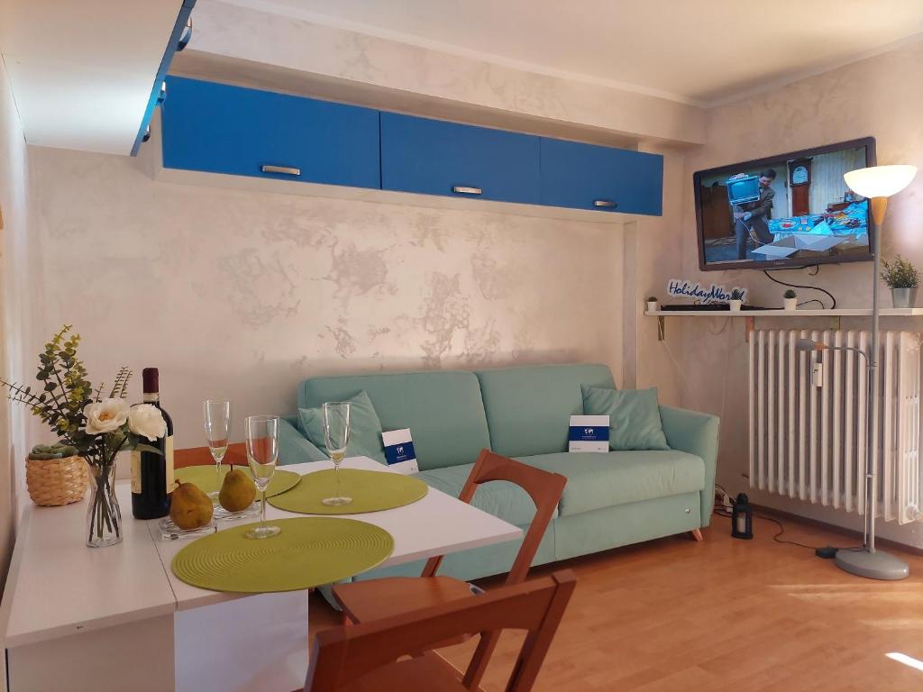 a living room with a table and a couch at House Fiocco di Neve by Holiday World in Limone Piemonte
