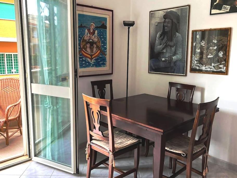 a dining room with a black table and chairs at Casa MaLù in Ladispoli