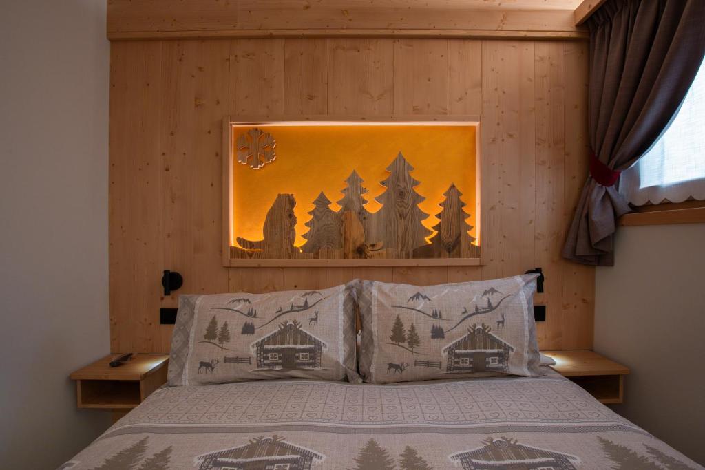 Rúm í herbergi á Chalet al Tabià