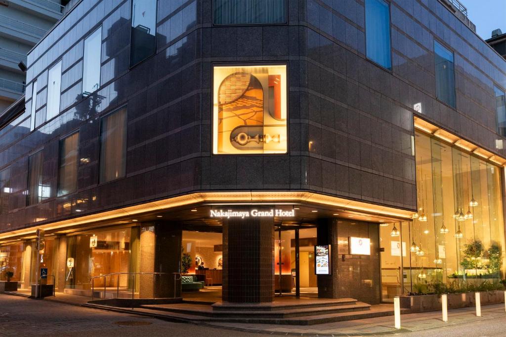 a building with a basketball sign on the side of it at Nakajimaya Grand Hotel in Shizuoka
