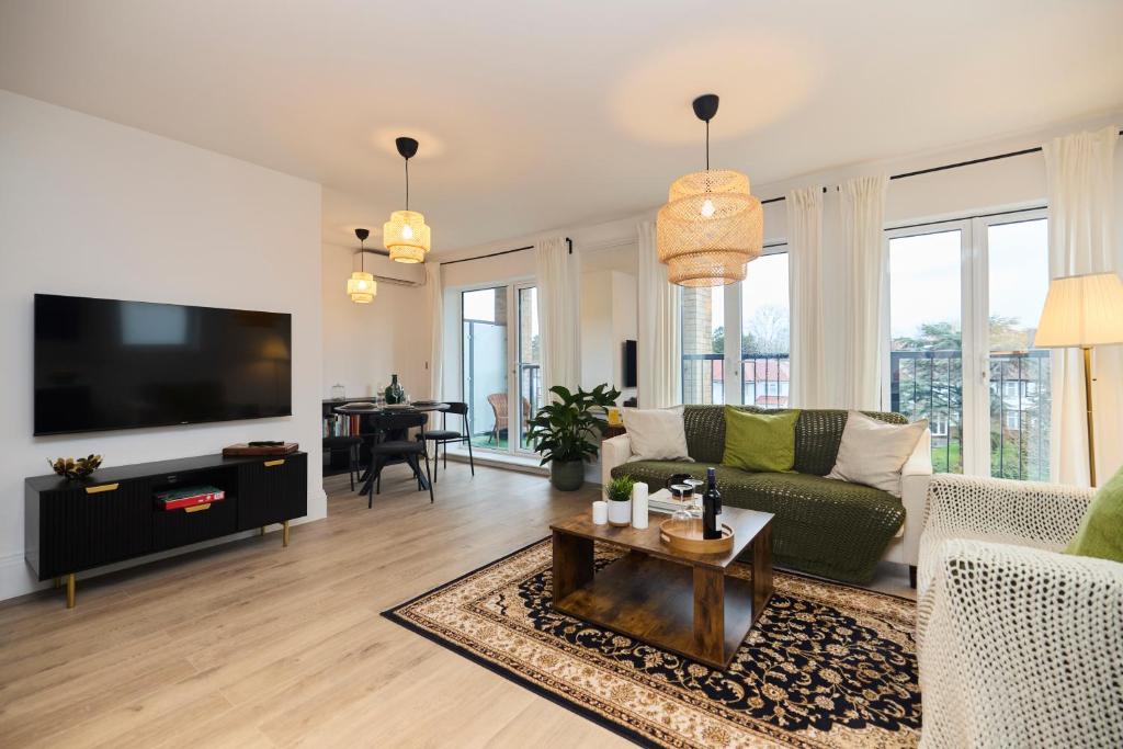 a living room with a couch and a tv at The Wembley Park Arms - Modern 2BDR Flat with Parking + Balcony in London