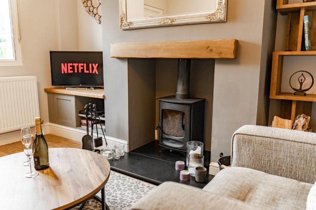 a living room with a wood stove in the corner at Cosy 2 bed cottage in charming village of Christleton - For up to 5 in Christleton