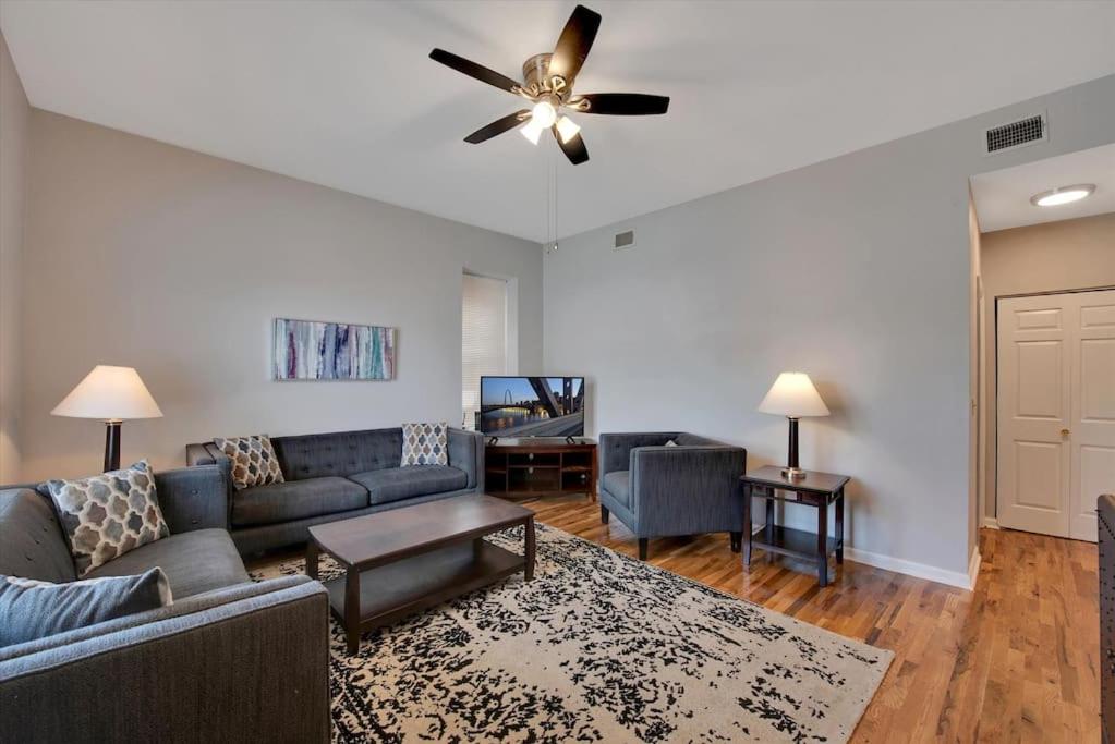 a living room with a couch and a ceiling fan at Breathtaking Unit in Shaw - 4 Queen beds 1E in Tower Grove