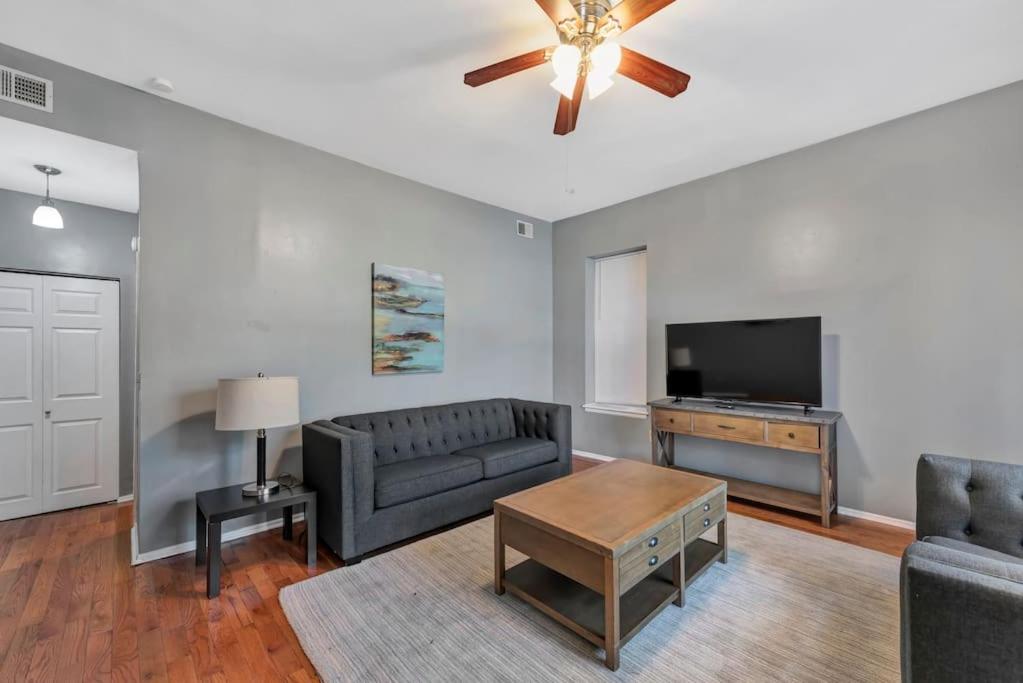 a living room with a couch and a flat screen tv at 2 Units Side-By-Side Sleeps 24 in Tower Grove