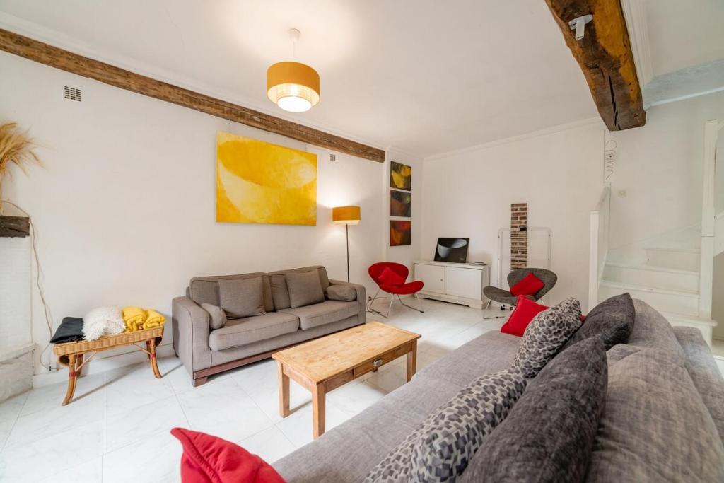 a living room with a couch and a table at Home - Saint Pèlerin - Séjour à Auxerre in Auxerre