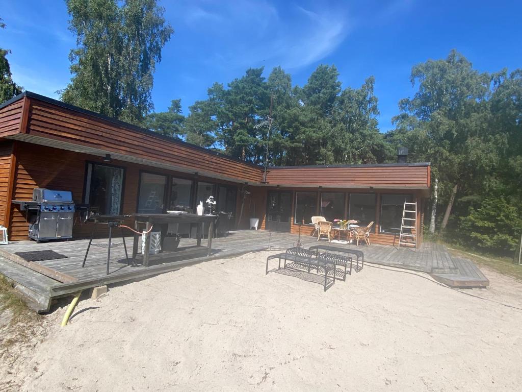 a large building with a picnic table and a grill at HolidayEscapes på Österlen in Simrishamn