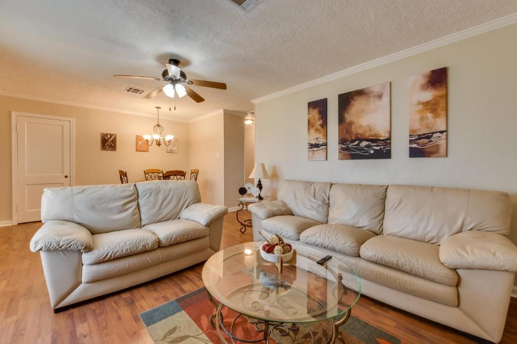 a living room with a couch and a glass table at Cozy Lake Charles Apartment 2 Mi to Downtown in Lake Charles