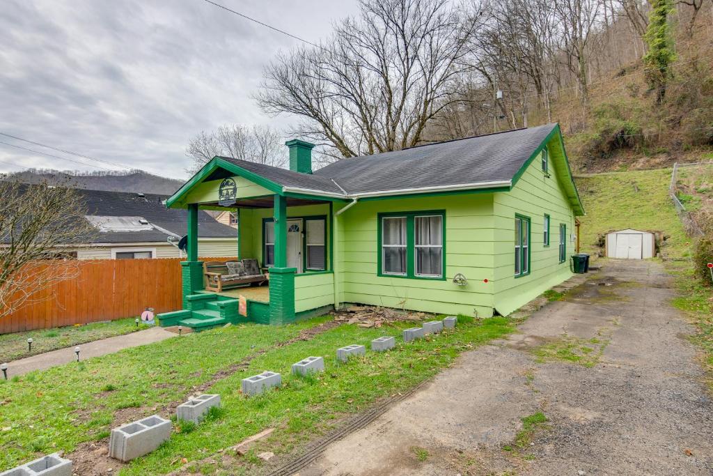 a small green house with a black roof at Matewan Vacation Rental Near Devil Anse Trail! 