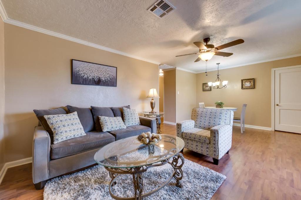 a living room with a couch and a table at Charming Lake Charles Apartment 2 Mi to Lake! in Lake Charles