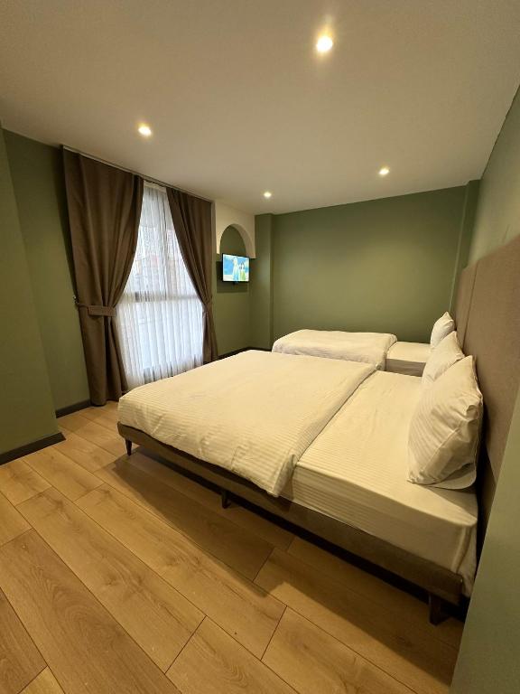 a bedroom with a large bed with white pillows at Heaven Inn Airport Hotel in Arnavutköy