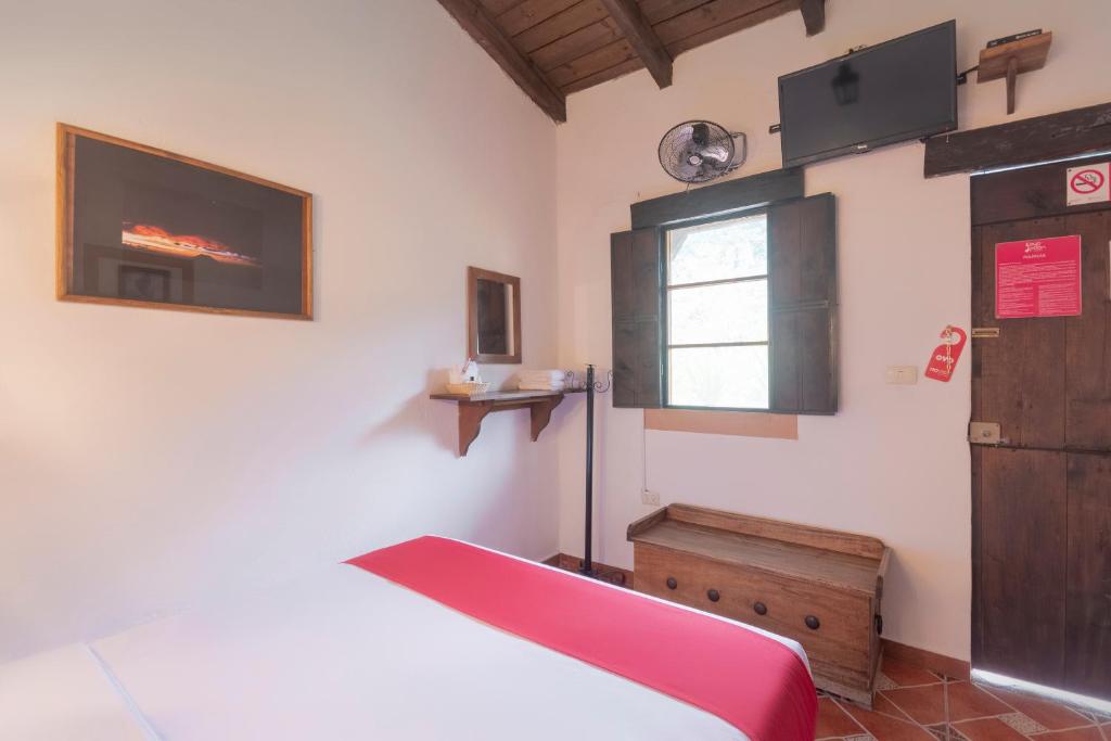 Postel nebo postele na pokoji v ubytování Hotel Coyopolan