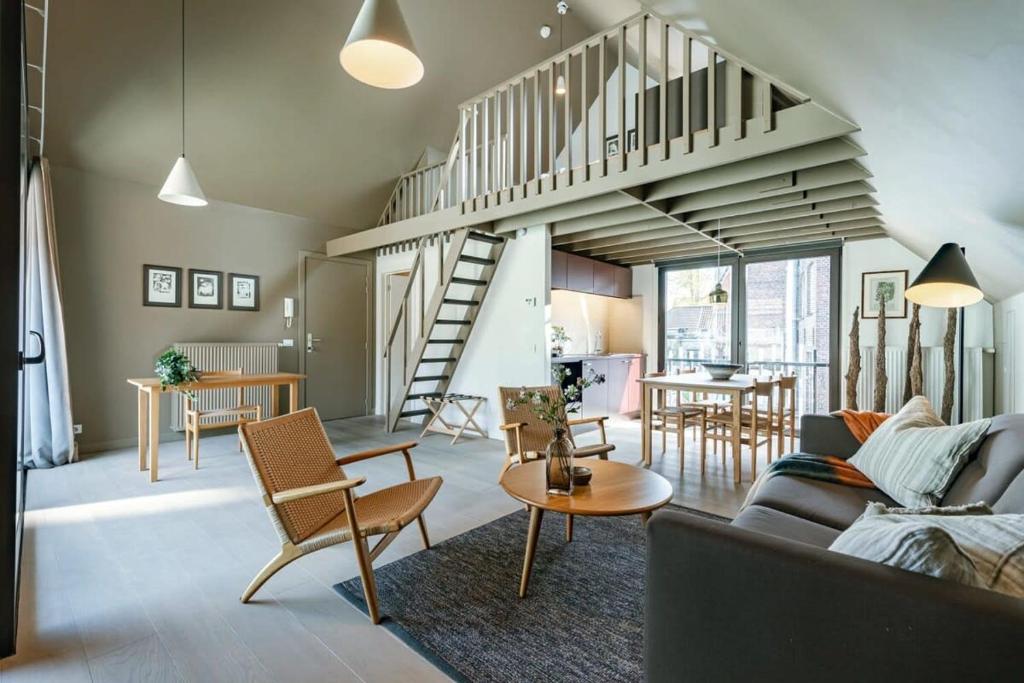 a living room with a couch and a staircase at Bonrepo Room 104 in Bruges