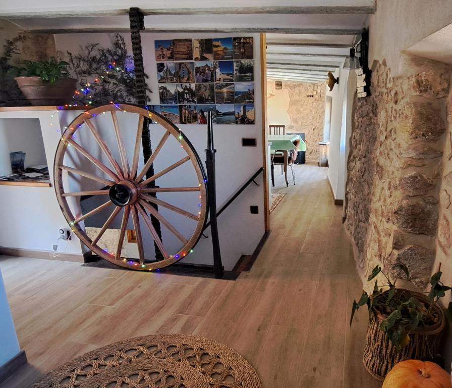 a large wooden wheel in a room with a table at Ca la Maria in Lilla