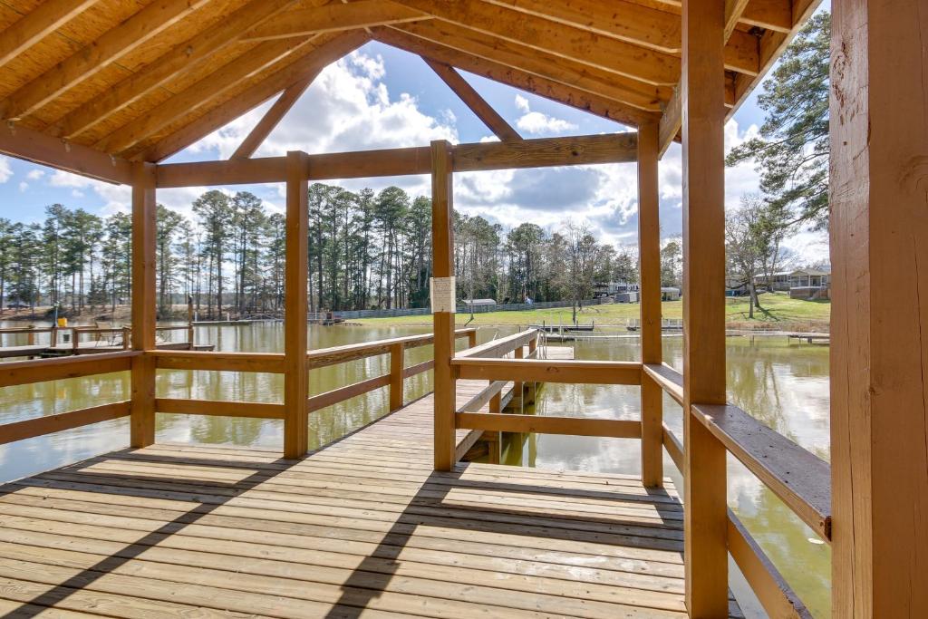 a wooden deck with a view of a lake at Pet-Friendly Lakehouse View Tower and Fire Pit! in Lake Murray Shores