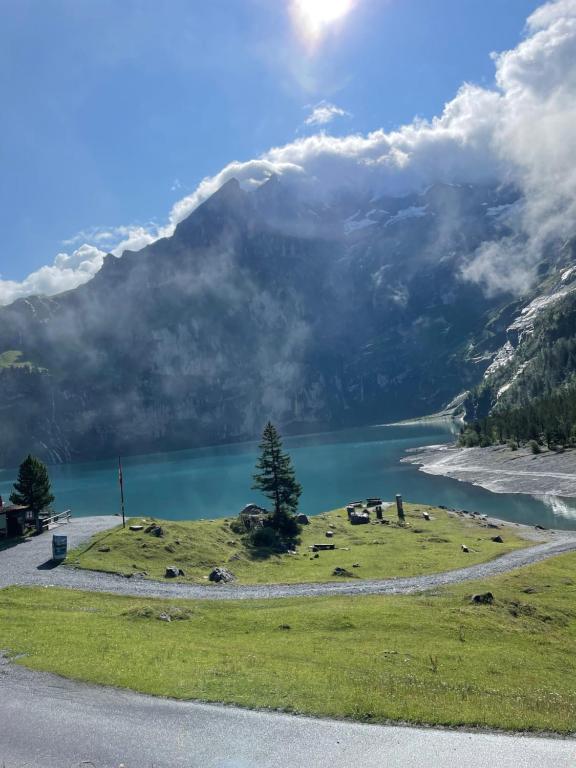 a view of a lake and a mountain at Lovely & great equipped wooden Alp Chalet flat in Kandersteg