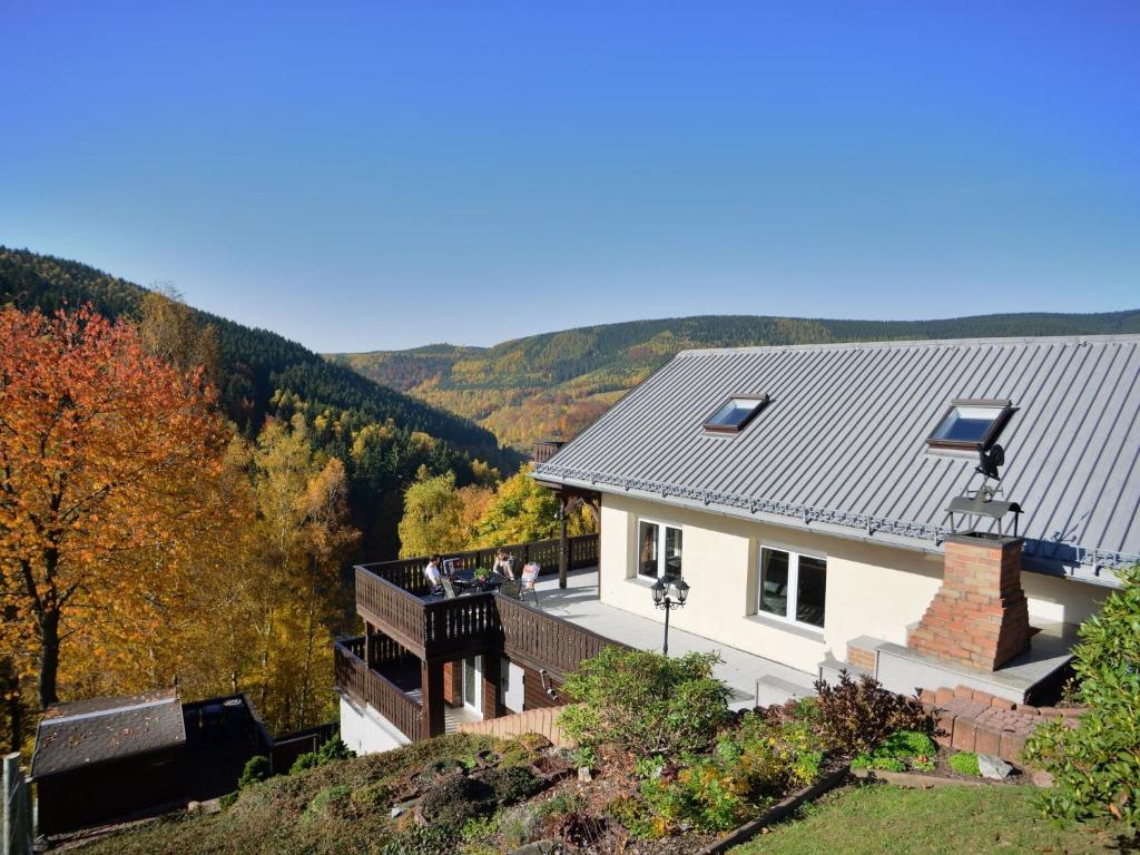 a house with solar panels on the roof at Majestic Holiday Home in Untersch nau with Jacuzzi in Unterschönau