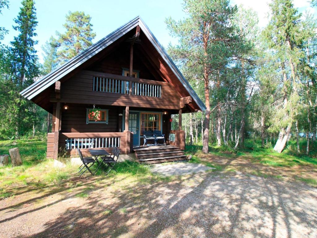 a log cabin in the woods with a porch at Holiday Home Marjatan mökki by Interhome in Ylikyro