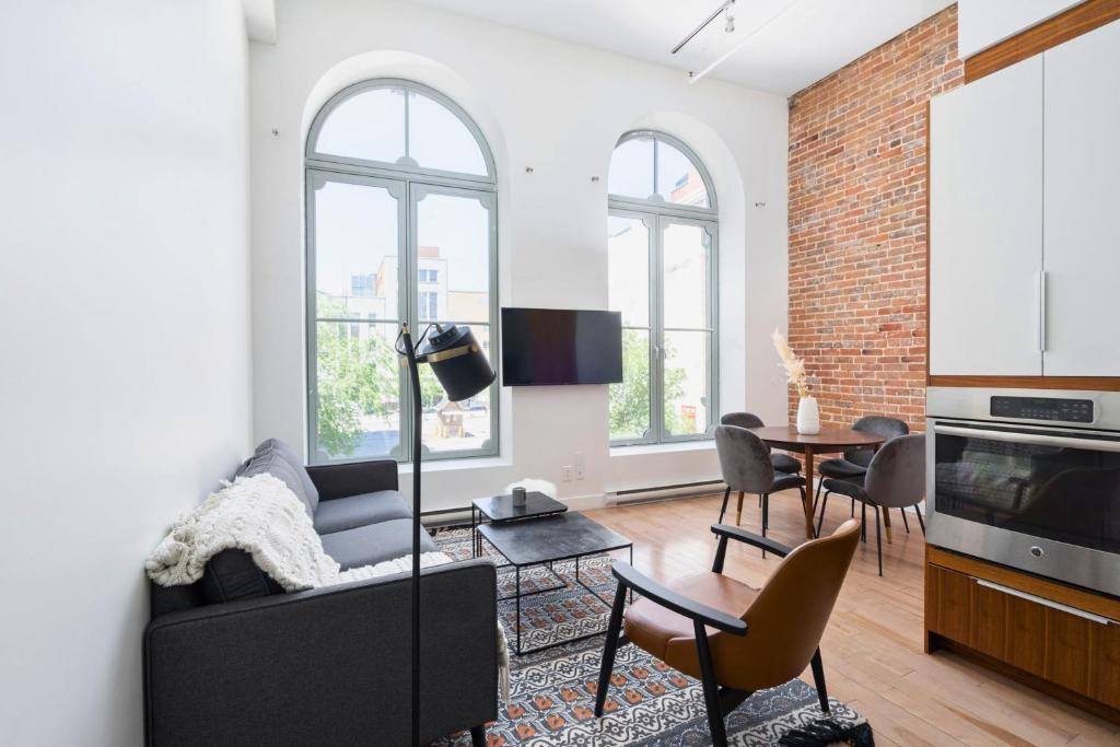 a living room with a couch and a table at Le Merrill - Vieux Montréal in Montreal