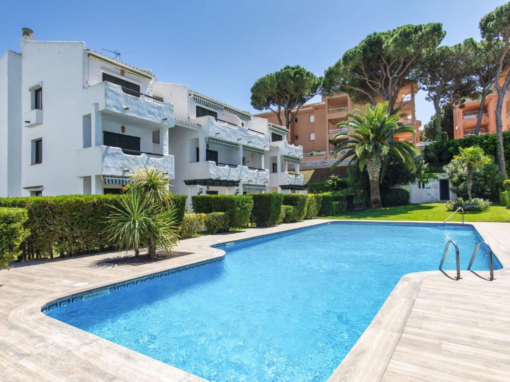 a swimming pool in front of a building at Apartment Coto Gamo Holiday Escape by Interhome in Pals