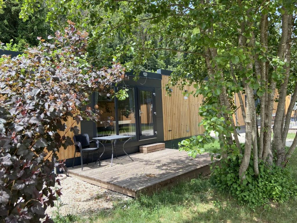 a tiny house in a garden with a table and chairs at Holiday Home Tiny Haus Antonia by Interhome in Riedenburg