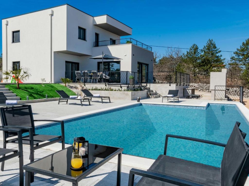 a villa with a swimming pool and a house at Villa Villa Karin by Interhome in Imotski