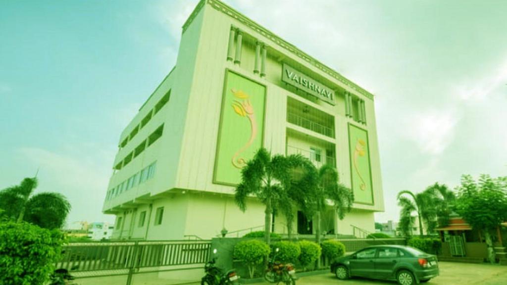 a building with a flamingo painted on the side of it at Vaishnavi Residency, Srikalahasti in Srikalahasti