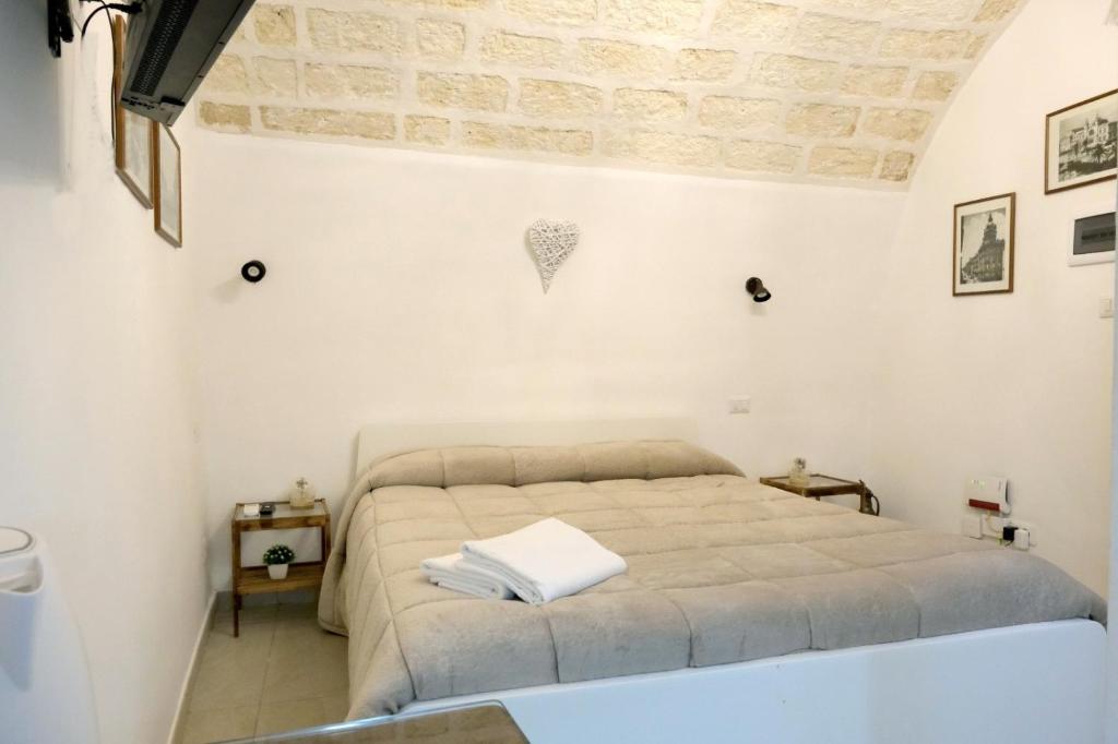 a bedroom with a bed in a white room at SAN MARCO in Bari