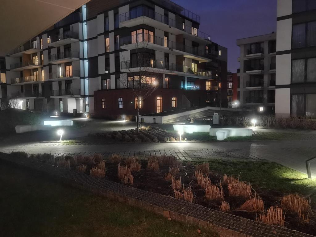 a building with lights in front of it at night at Novum apartment in the city center in Kraków