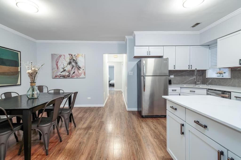 a kitchen with a dining table and a refrigerator at Beautiful Remodeled Penthouse Unit in Old Town in Chicago