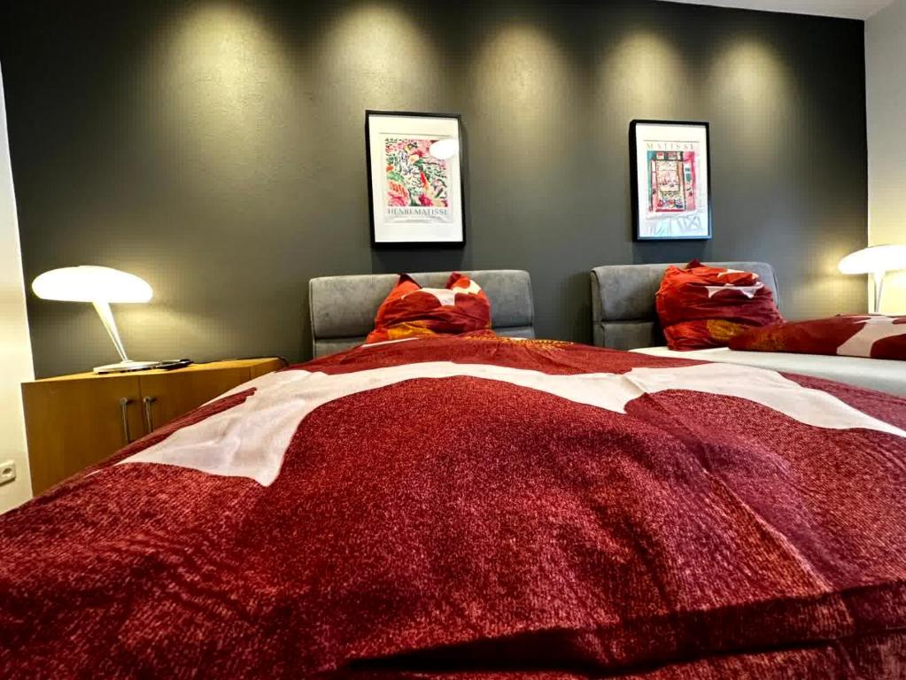 a bedroom with a bed with a red blanket at casa ECH Ferienhaus Oberelsbach in Oberelsbach
