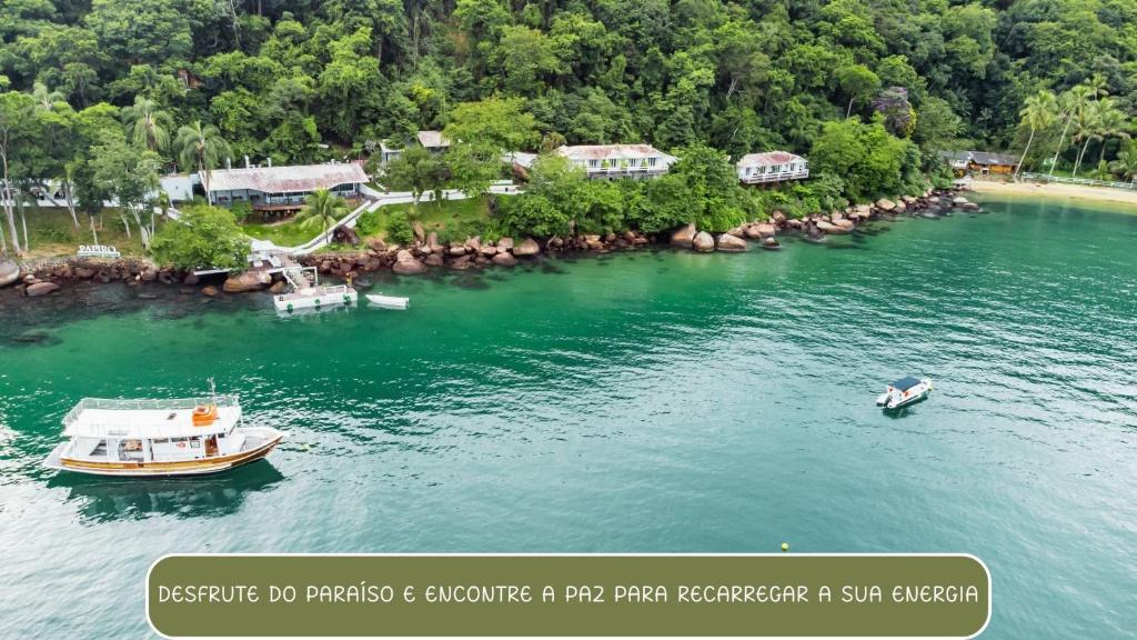 an aerial view of a river with two boats at Pousada Papiro Boutique in Abraão