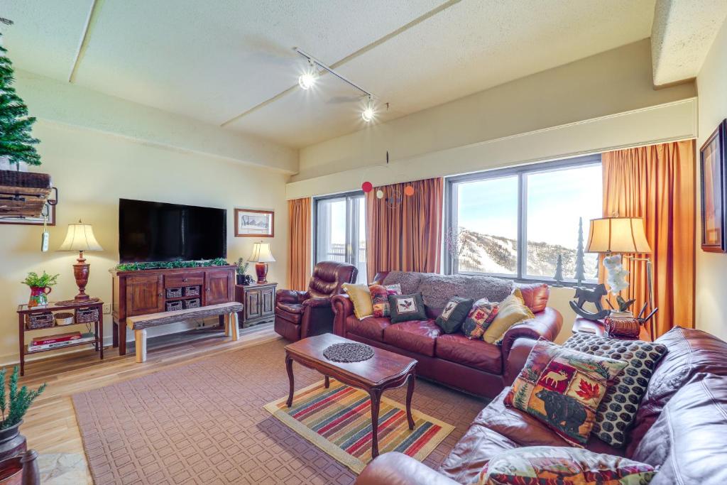 a living room with a couch and a tv at Pool & Hot Tub: Mtn-View Condo in Sugartop Resort! in Sugar Mountain