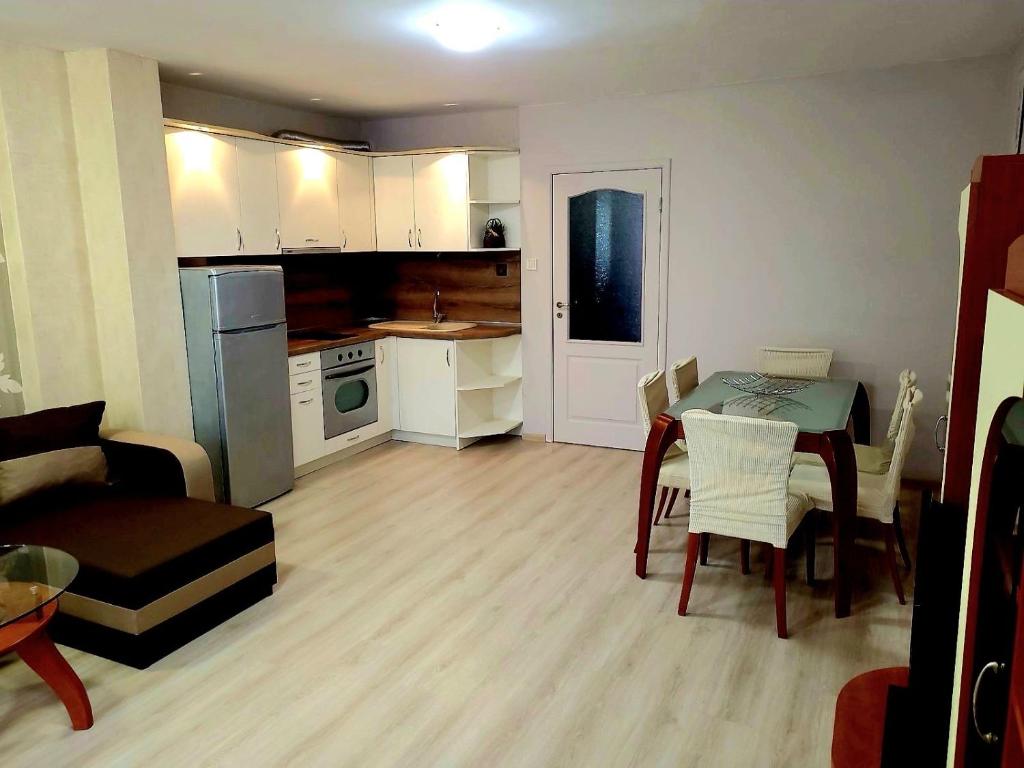 a small kitchen and living room with a table and chairs at Lux Apartment Sisi in Burgas City