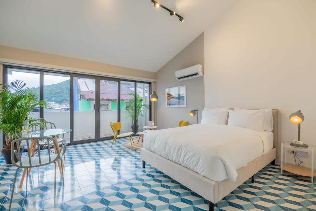 a bedroom with a large bed and a table and chairs at Stylish Loft in Santa Ana in Panama City