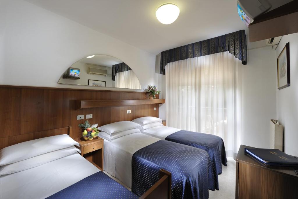 Postel nebo postele na pokoji v ubytování Hotel Vina De Mar