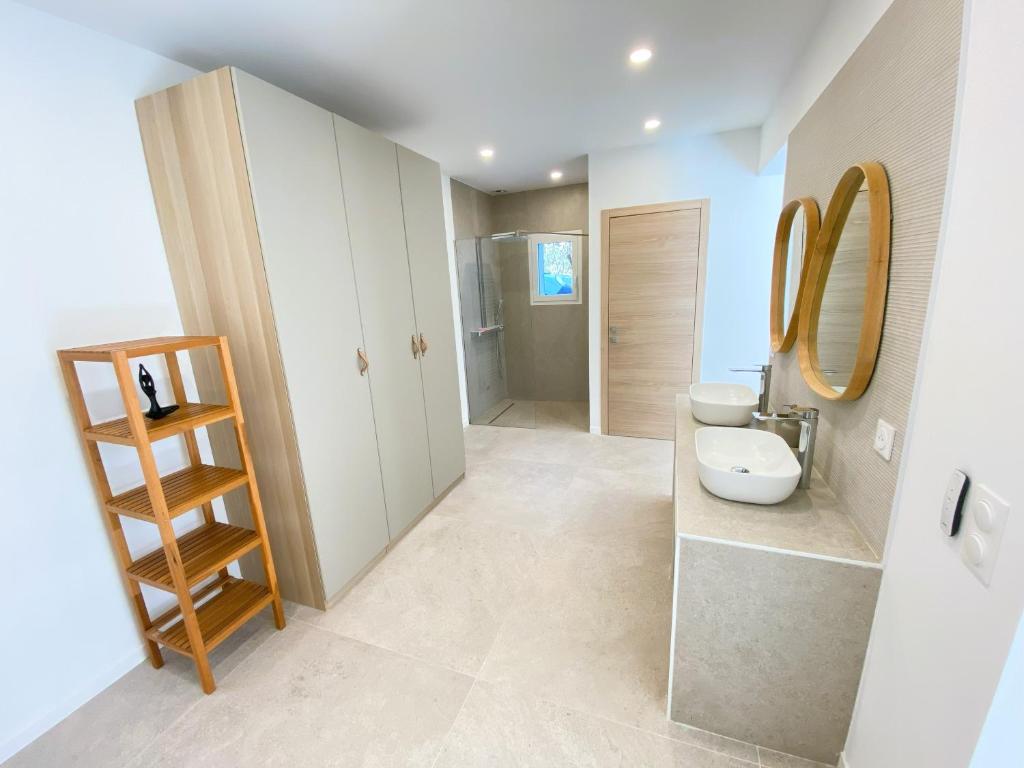 a bathroom with a sink and a toilet and a mirror at Villa d'exception piscine privée et vue mer in Saint-Cyr-sur-Mer