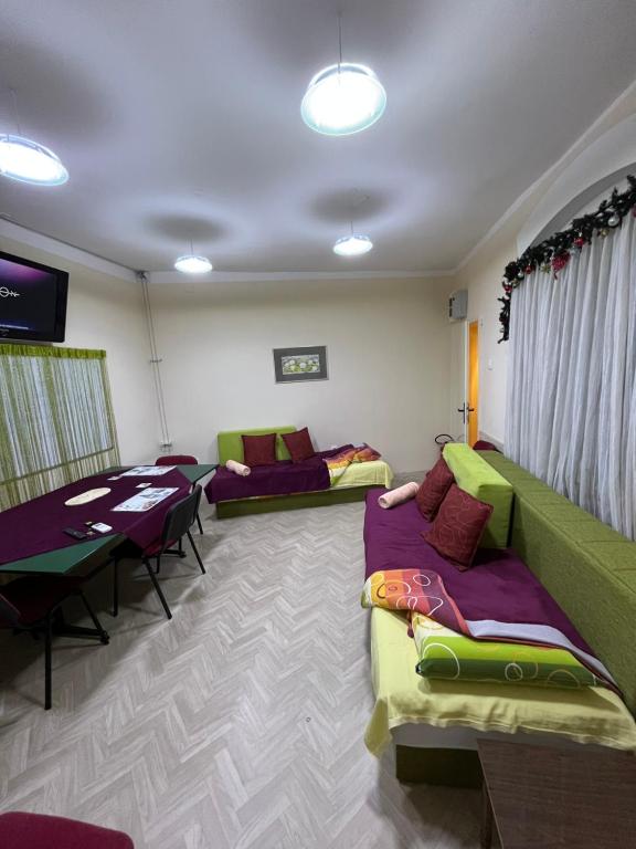 a living room with couches and a table and chairs at Cozy apartment in the center of Novi Sad! in Novi Sad