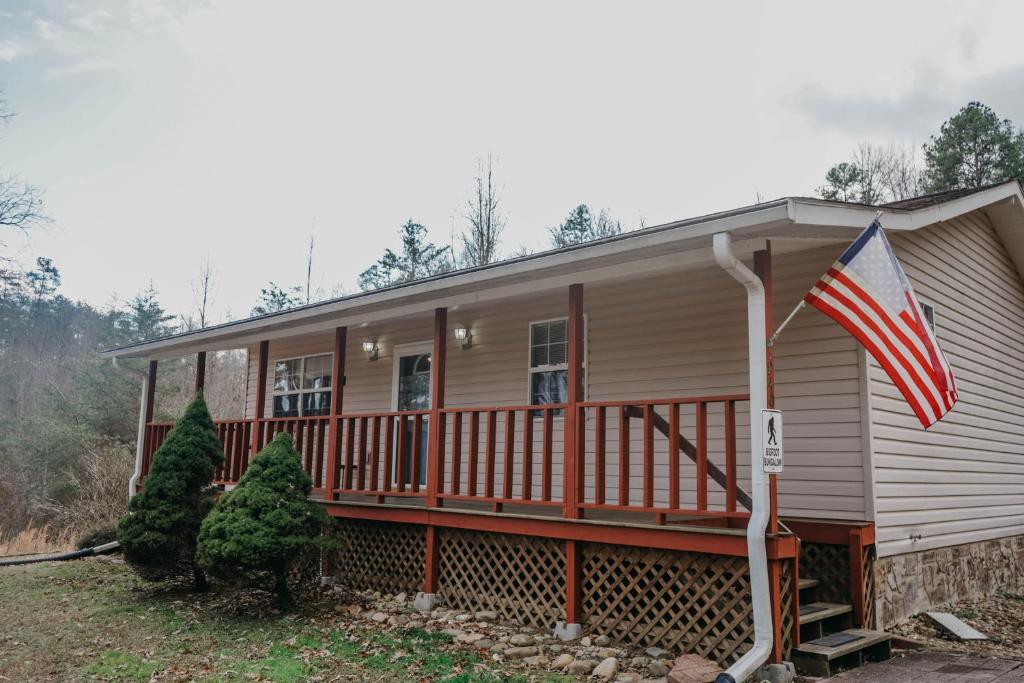 a house with a porch and an american flag at Big Foot Bungalow in Sevierville