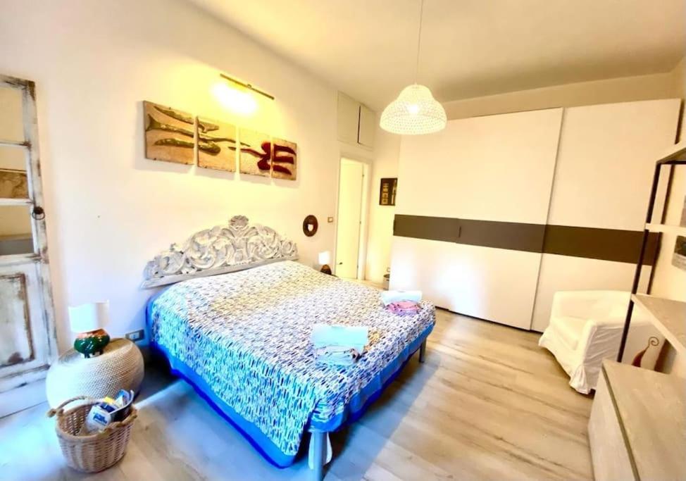 a bedroom with a bed with a blue comforter at Fine and large flat with terrace, near the centre and stadium in Rome